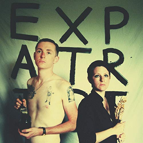 "Album cover with man and woman standing back-to-back, holding bottle and feather."