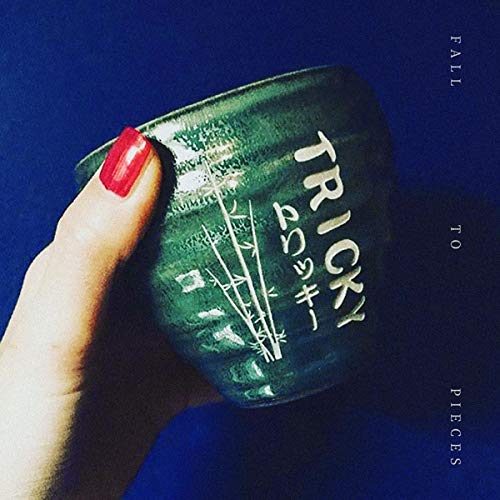 CD cover for Tricky’s “Fall To Pieces” featuring green foliage and a hand.