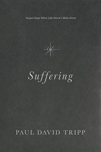 Dark gray book cover with the title "Suffering" and a starburst image.