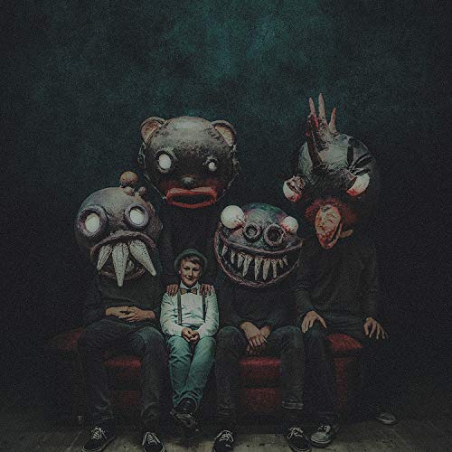 "Album cover featuring three men and four grotesque masks against a dark background."