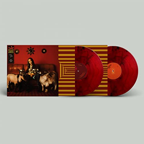 Red marbled vinyl record with album cover featuring a person and animals.