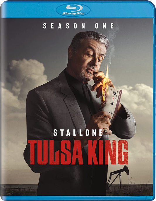 Sylvester Stallone lights a burning boarding pass with a cigar on the Tulsa King cover.