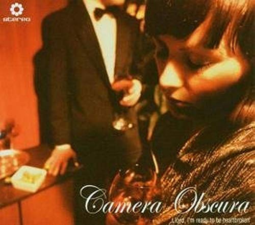 Record cover featuring a man and woman with drinks in a dimly lit room.