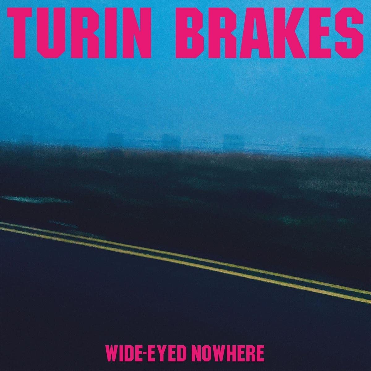 The alt text for this image is: "Album cover with road and cityscape, 'Turin Brakes Wide-Eyed Nowhere'."