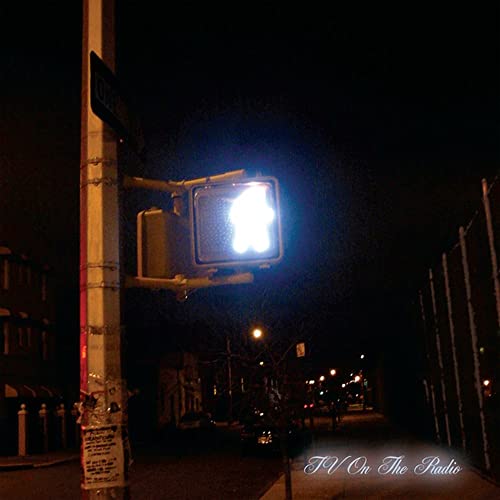 Night street scene with a bright traffic light, album cover art.