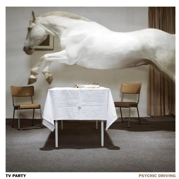 Vinyl album cover: a white horse appears to leap over a dining table.