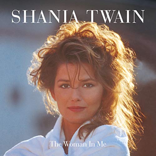 Shania Twain album cover, "The Woman In Me," featuring a portrait of the singer.