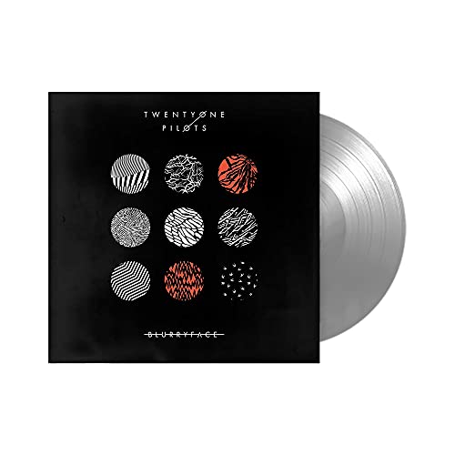 Silver vinyl record and black album cover with nine circular designs.