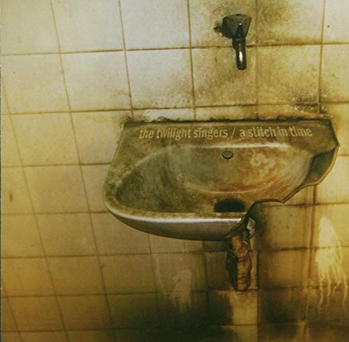 CD cover: a stained, old sink against a tiled wall.