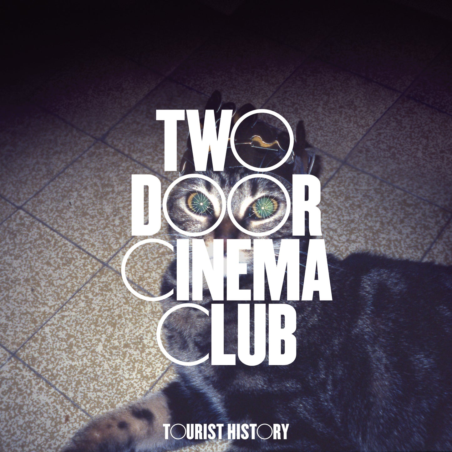 Album cover for Two Door Cinema Club’s “Tourist History” with bold text and a bear.