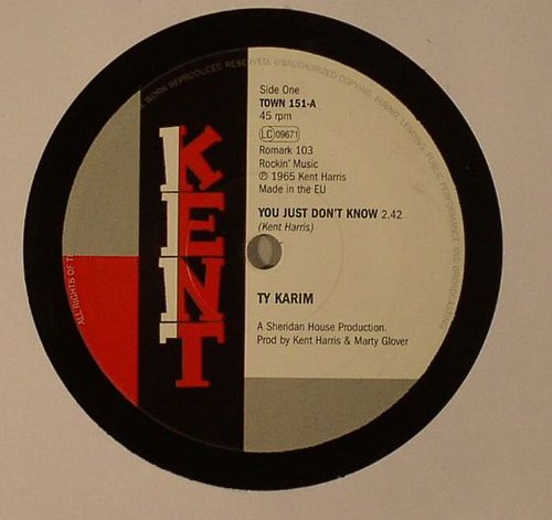 Black vinyl record with red, white, and gray label design, featuring song title and artist.