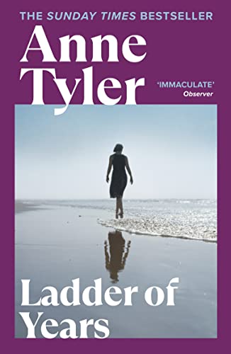 Book cover: woman walking toward the sea, purple and white text.