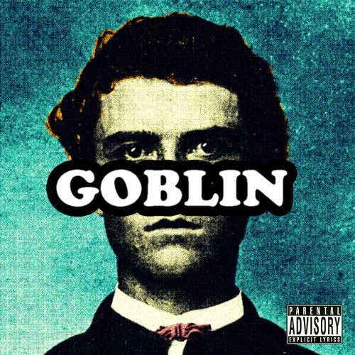 Portrait of a man with the word GOBLIN obscuring his eyes on teal background.
