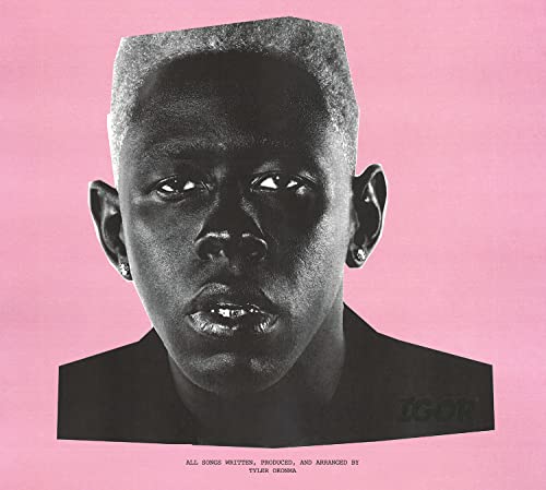 Black and white portrait of Tyler, The Creator against a solid pink background.