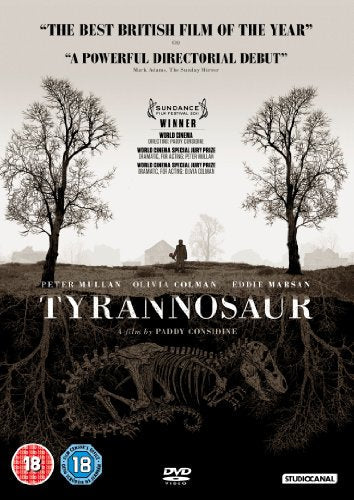 DVD cover for "Tyrannosaur" with a person standing between bare trees and dinosaur skeleton.