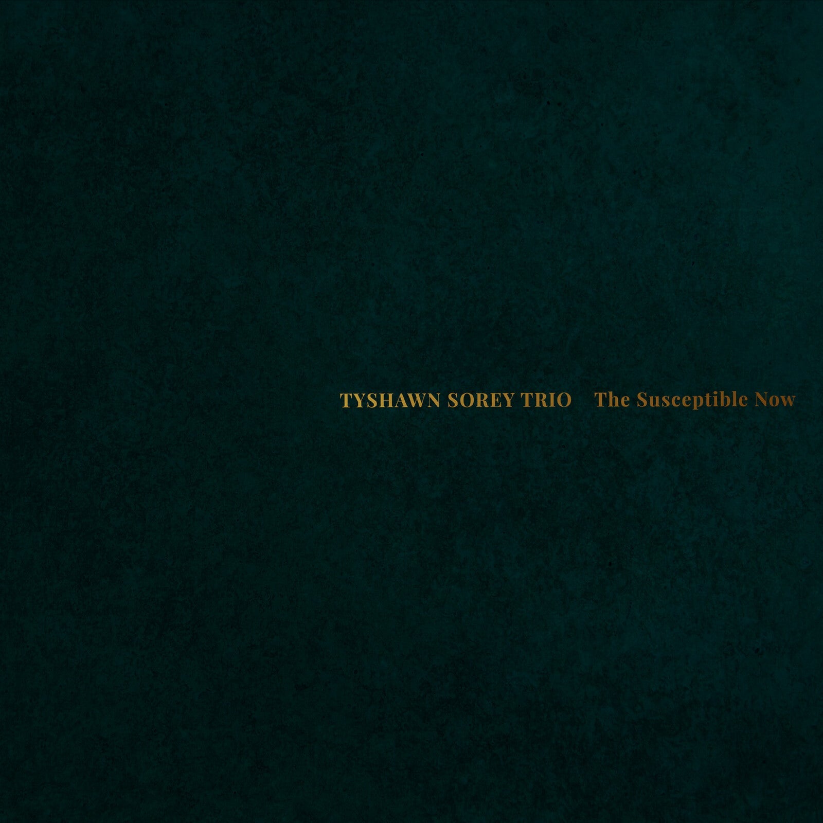 Dark teal textured album cover with gold text: "Tyshawn Sorey Trio.