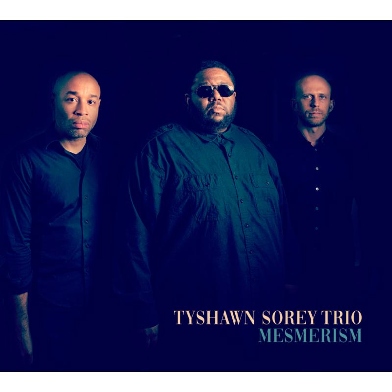 Album cover featuring three men, text “Tyshawn Sorey Trio - Mesmerism”.