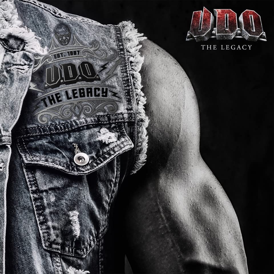 Album cover for U.D.O. - The Legacy, featuring denim and an arm.