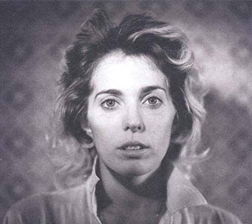 Black and white portrait of a woman with wavy hair, looking forward.