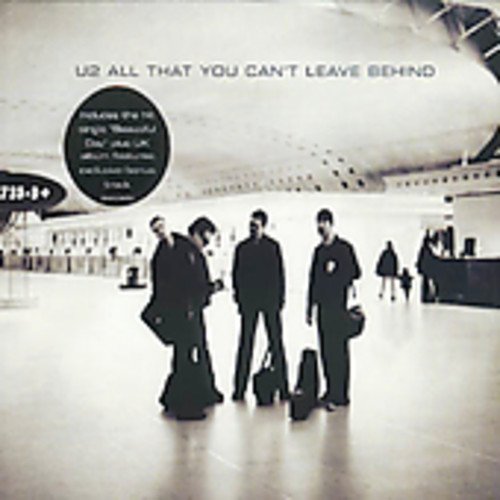 U2 album cover: band members in an airport, grayscale image.