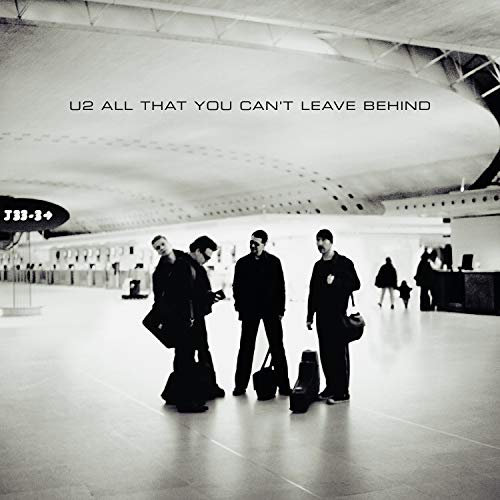Black and white photo of the band U2 standing in an airport terminal.