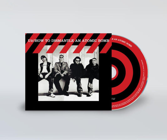 U2 album cover with band photo and accompanying compact disc.