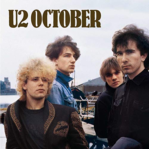The band U2 posing outdoors with the text U2 OCTOBER at the top.