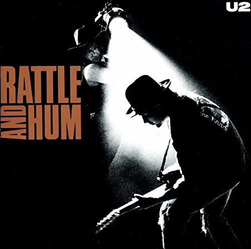Black and white album cover featuring a silhouetted guitarist lit by a spotlight.
