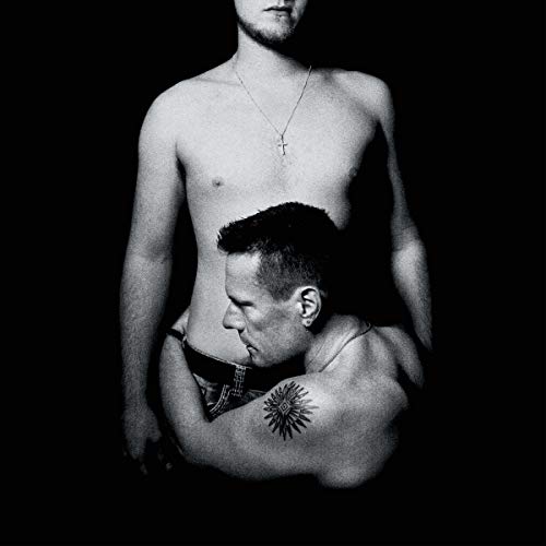 Black and white album cover featuring two shirtless men embracing.