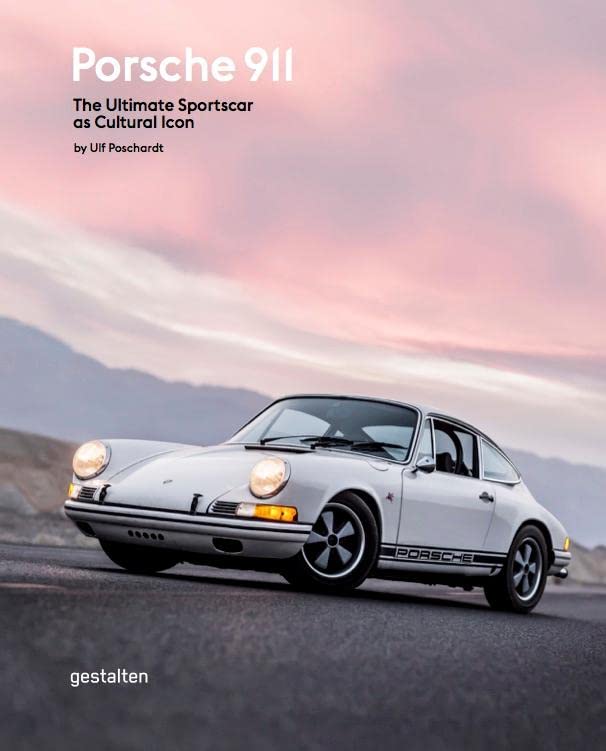 White Porsche 911 parked on a road against a sunset sky.