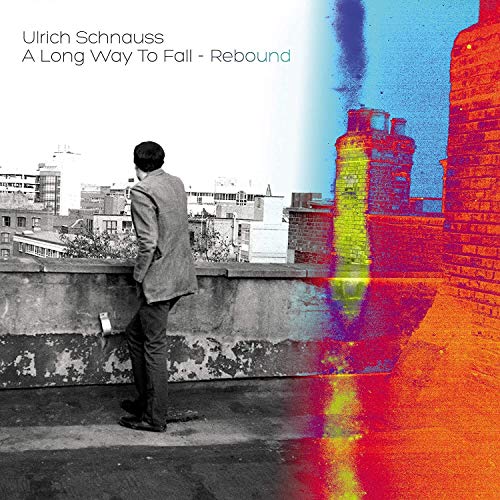 CD cover: man on rooftop with blurred city and brick tower.