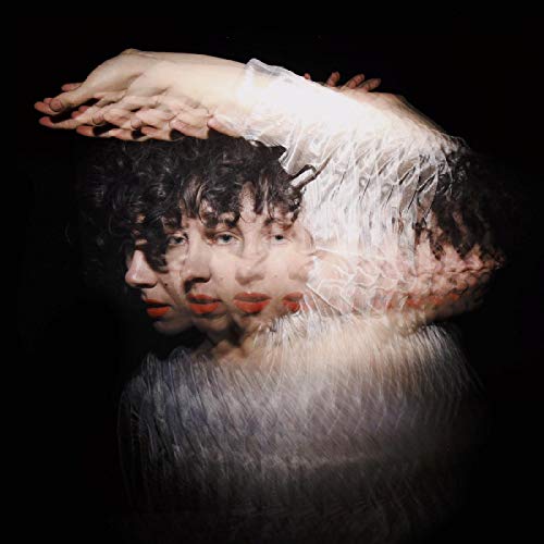 Multiple exposures of a person with curly hair and white feathers.