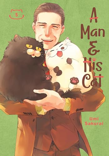 Man in brown suit holding a black and white fluffy cat.