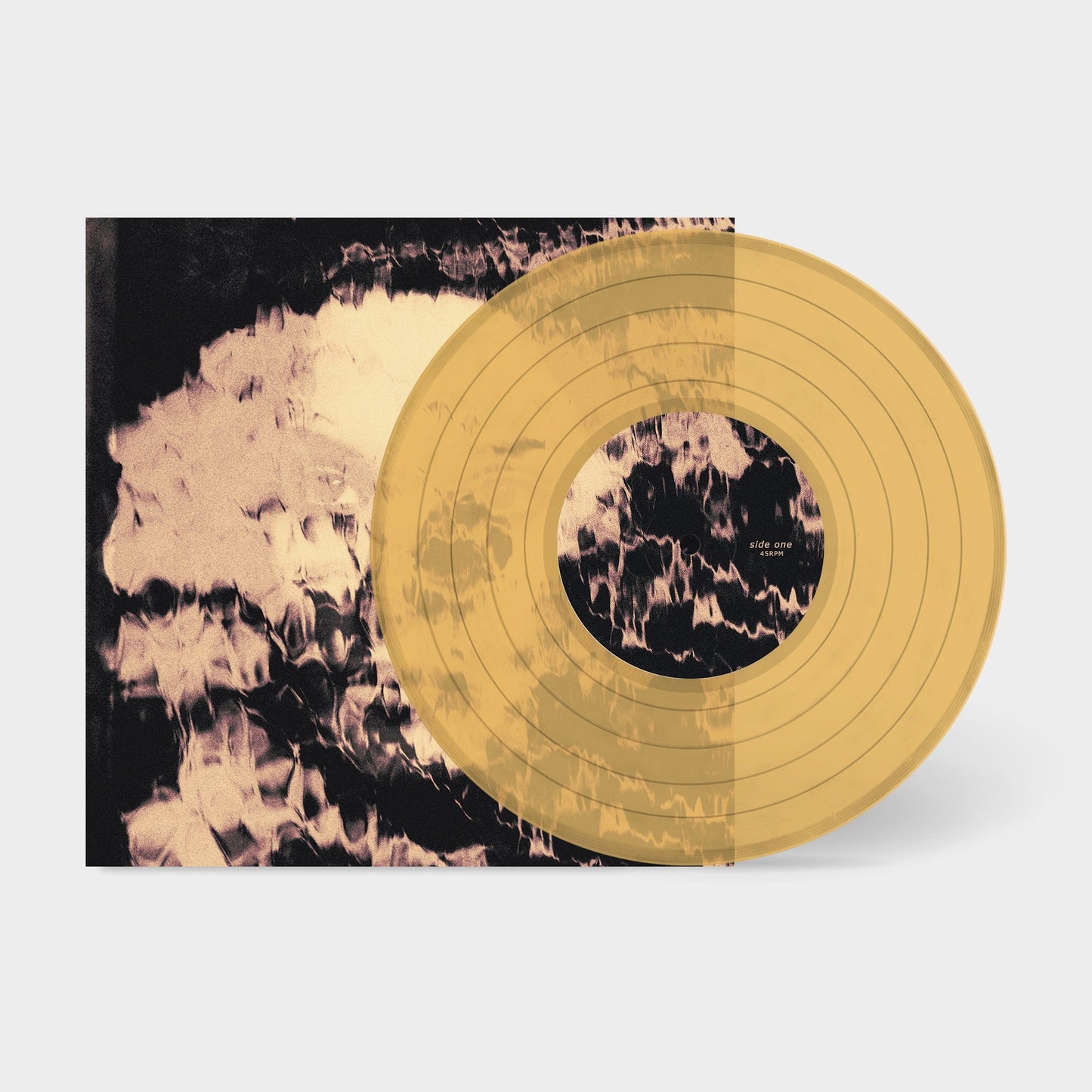 Yellow vinyl record with blurred, abstract cover art beside it.