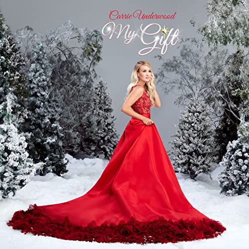 Woman in red dress standing in snowy landscape with frosted trees behind her.