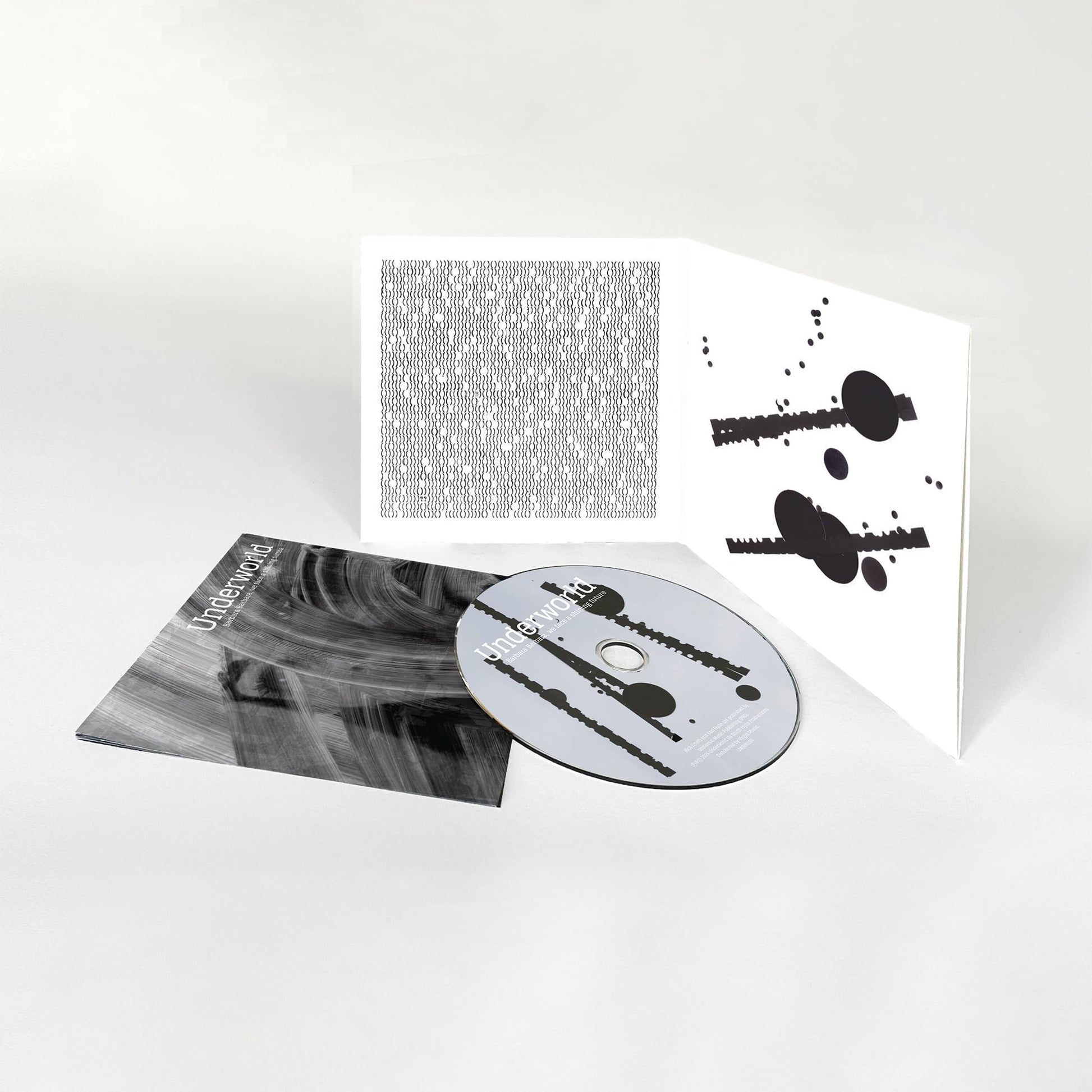 Underworld CD album with gatefold sleeve featuring abstract black and white graphic patterns.