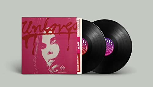 Pink vinyl album "Unloved" with two black records beside it.