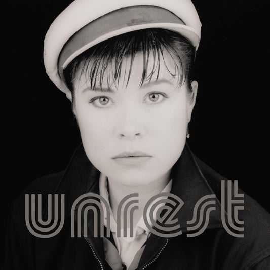 Black and white portrait of a woman with a cap, album title "Unrest".