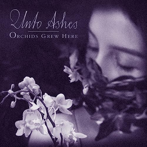 CD cover: woman’s face with white orchids, purple and grey tones.