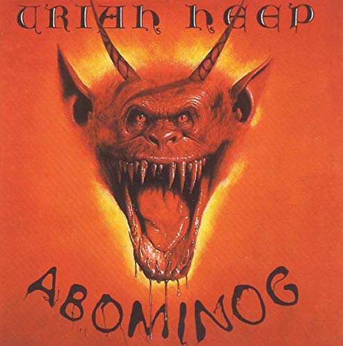Album cover featuring a horned monster with a wide open mouth on orange background.
