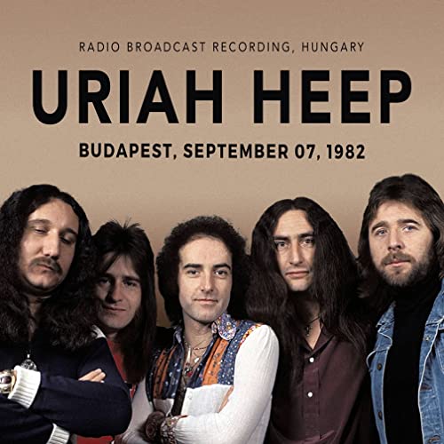 Uriah Heep band portrait from 1982, with band name and concert details.