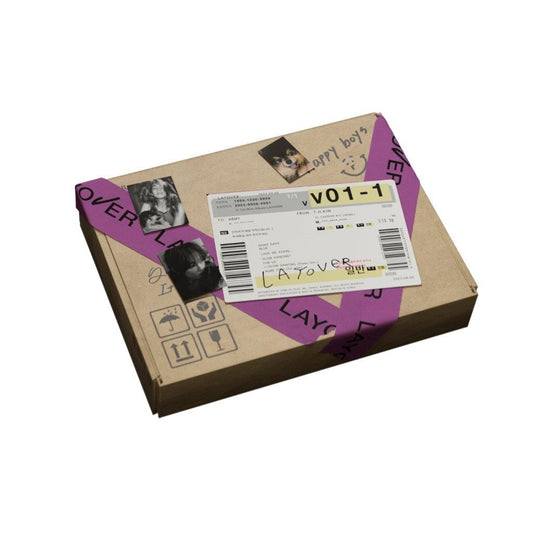 "Brown cardboard box with purple tape and a barcode sticker on top."