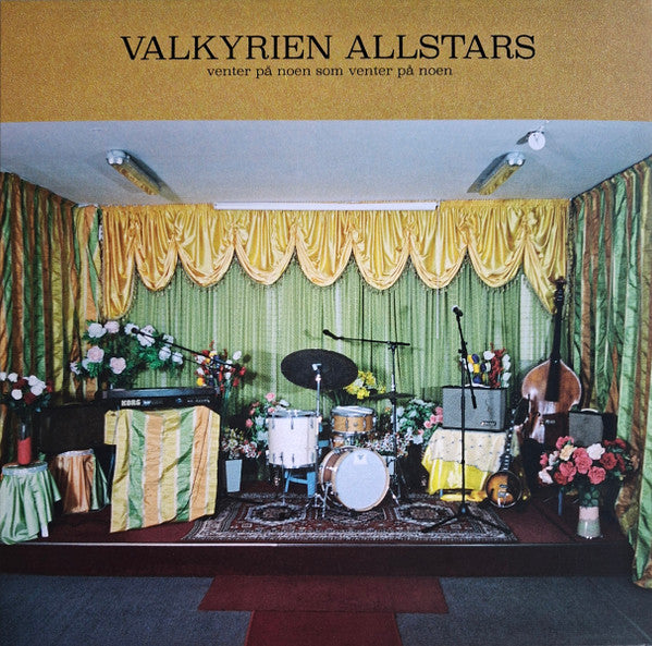 Vinyl record cover: band setup with instruments on a stage with curtains.