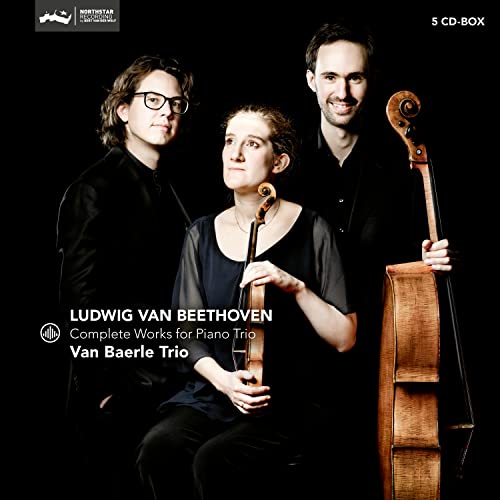 Three musicians of the Van Baerle Trio posing with a cello against black background.