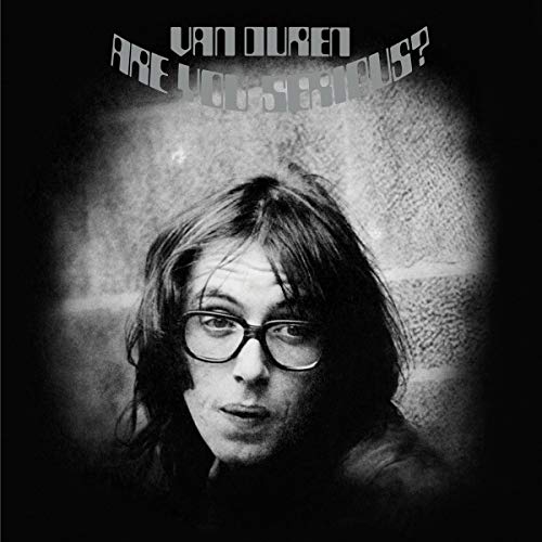 Black and white vinyl album cover featuring a man with glasses and long hair.