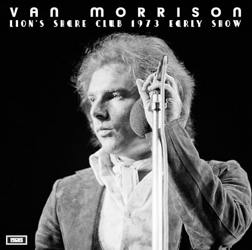 Black and white portrait of Van Morrison singing into a microphone.