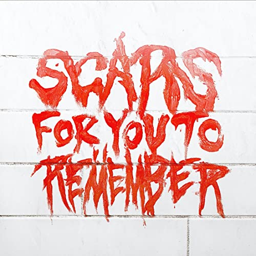 Red graffiti on white brick wall reading Scars For You To Remember.
