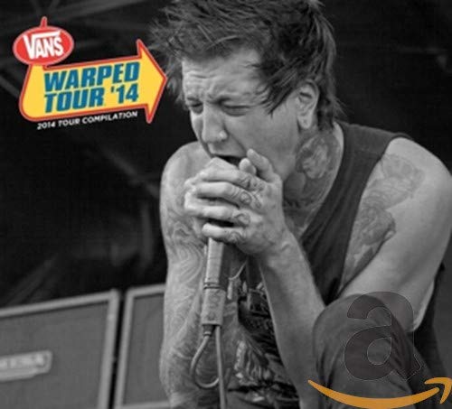 Black and white image of a tattooed musician singing into a microphone.