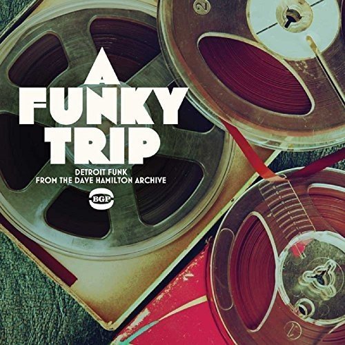 Vinyl record cover with text "A Funky Trip" and reel-to-reel tapes.