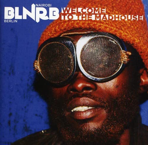 CD cover: Man with large goggles and orange knit hat.